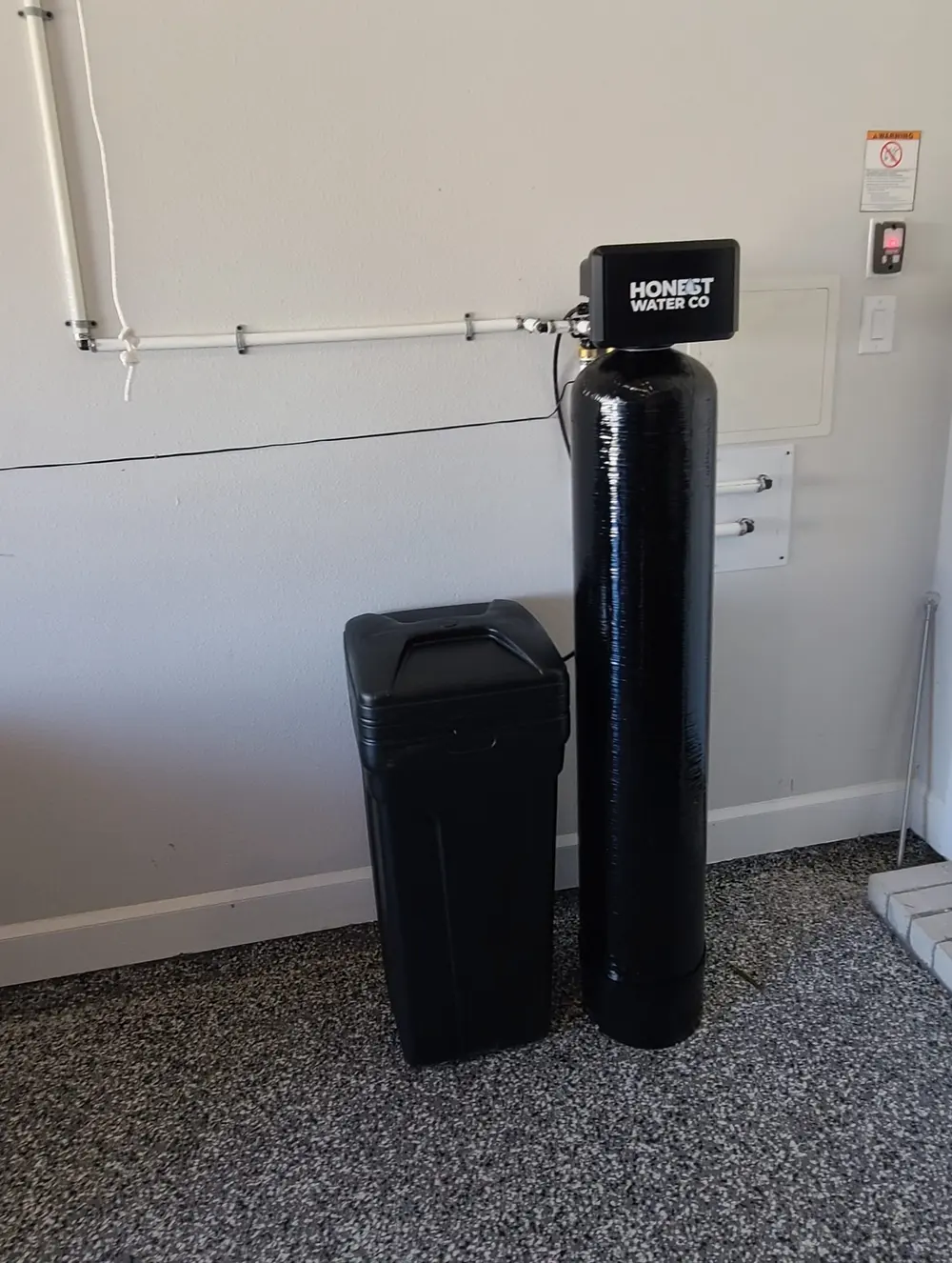 Honest Water Co softener installed in a garage with an epoxy-coated floor