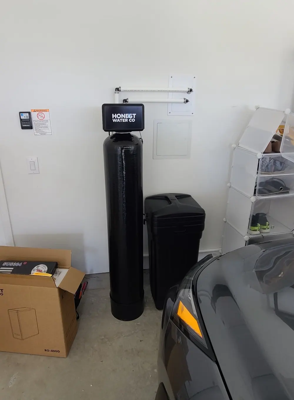 Softener, brine tank and wall-mounted filter housings in a residential garage